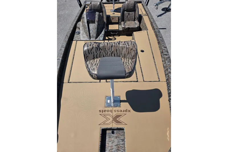 Slide: The Image of 2026 Xpress H20 Bass boat interior with camouflage seating and tan deck. - 18