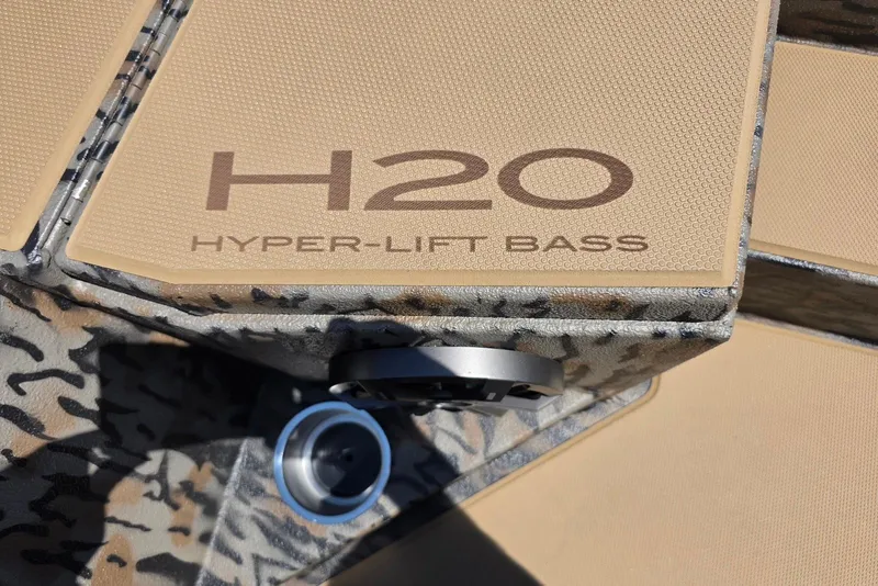 Slide: The Image of 2026 Xpress H20 Bass boat with Hyper-Lift design, featuring camo pattern and textured surface. - 20