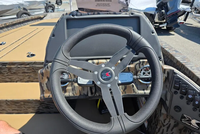 Slide: The Image of 2026 Xpress H20 Bass boat steering wheel and dashboard controls. - 22