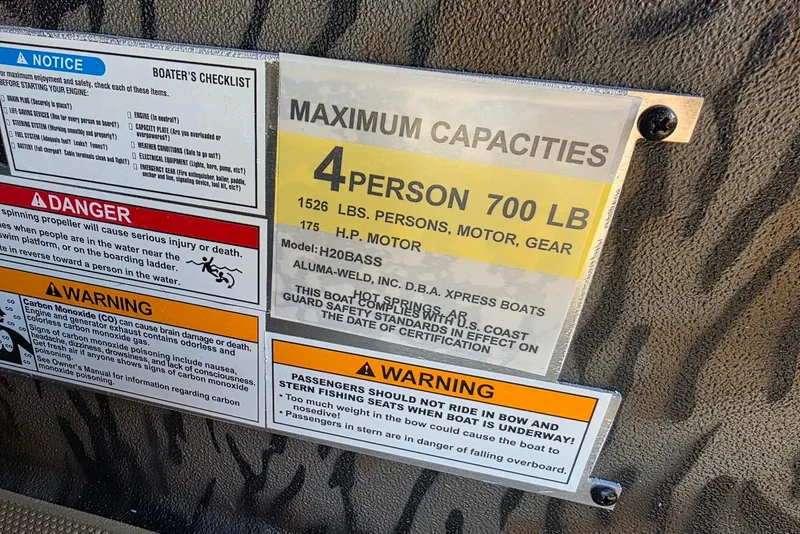 Slide: The Image of 2026 Xpress H20 Bass boat capacity and safety warnings label. - 25