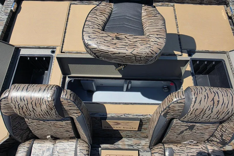 Slide: The Image of 2026 Xpress H20 Bass boat interior with camo seats and storage compartments. - 27