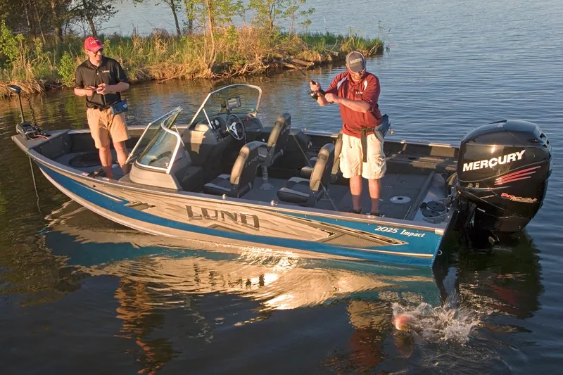 Slide: The Image of Manufacturer Provided Image: 2016 Lund 2025 Impact fishing boat on a lake with two anglers. - 13