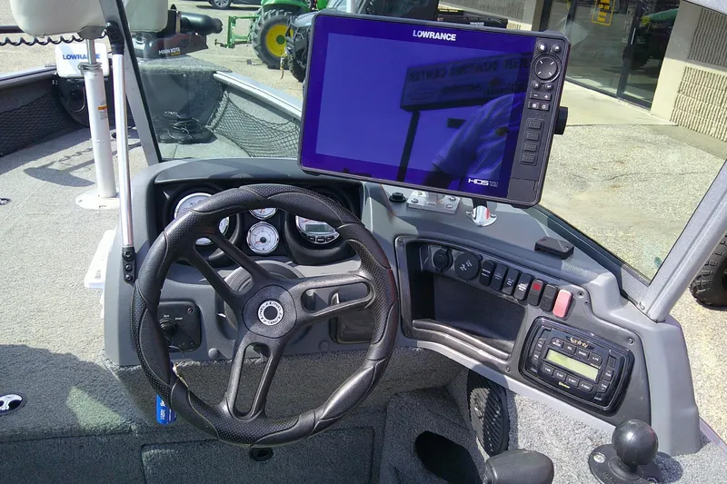 Slide: The Image of 2016 Lund 2025 Impact boat dashboard with steering wheel and Lowrance HDS-12 display. - 6