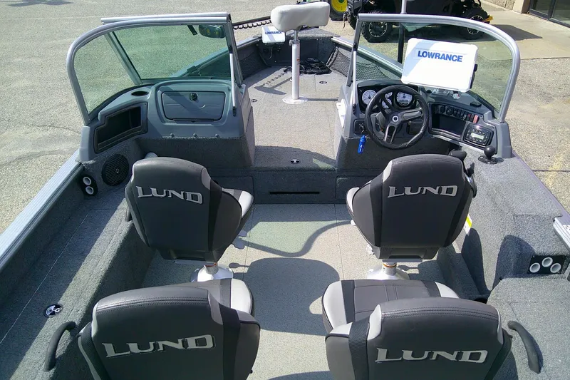 Slide: The Image of 2016 Lund 2025 Impact boat interior with four seats and Lowrance equipment. - 7