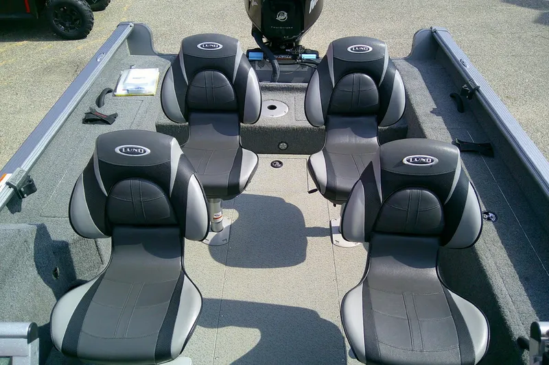 Slide: The Image of 2016 Lund 2025 Impact boat interior with four black and gray seats. - 8
