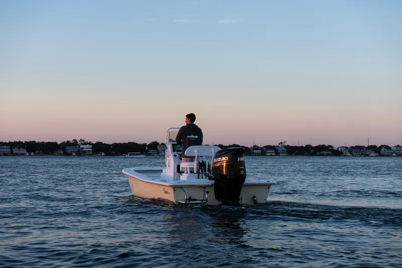 Slide: The Image of A 2016 Intruder 198 Tunnel Drive boat on calm waters at sunset. - 5