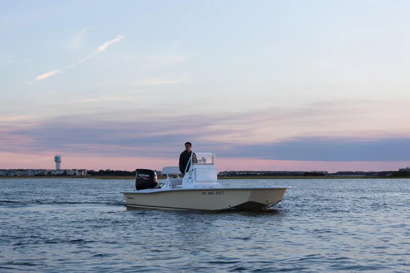 Slide: The Image of Intruder 198 TUNNEL DRIVE boat on calm water at sunset, 2016 model. - 9