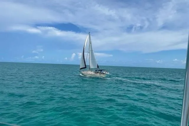 Slide: The Image of Sailboat Island Packet 420 (2002) cruising on clear blue ocean under a partly cloudy sky. - 1