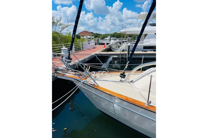 Slide: The Image of Island Packet 420 sailboat docked at marina, 2002 model, under a bright blue sky. - 12