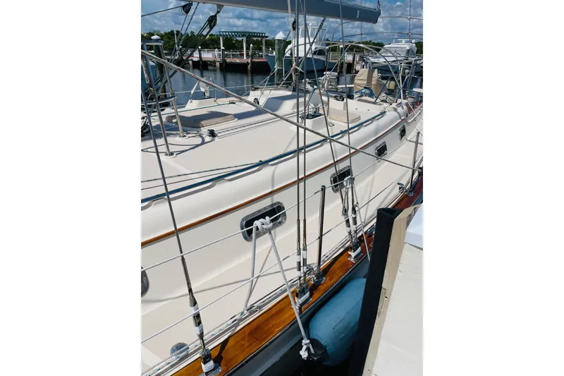 Slide: The Image of 2002 Island Packet 420 sailboat docked, showcasing deck and rigging details. - 13