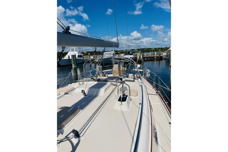 Slide: The Image of 2002 Island Packet 420 sailboat docked under a clear blue sky. - 19