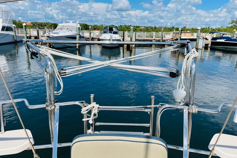 Slide: The Image of Island Packet 420 sailboat docked at marina, clear blue sky, calm water, 2002 model. - 26