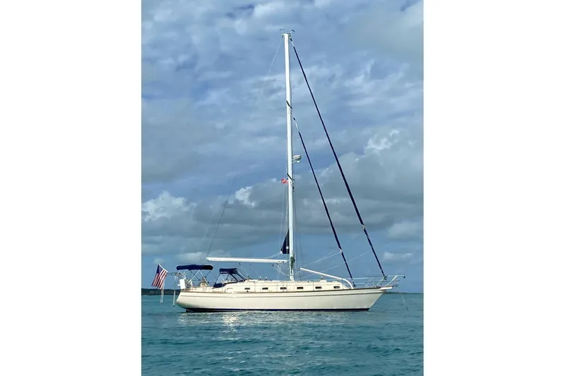 Slide: The Image of 2002 Island Packet 420 sailboat on calm ocean under cloudy sky. - 3