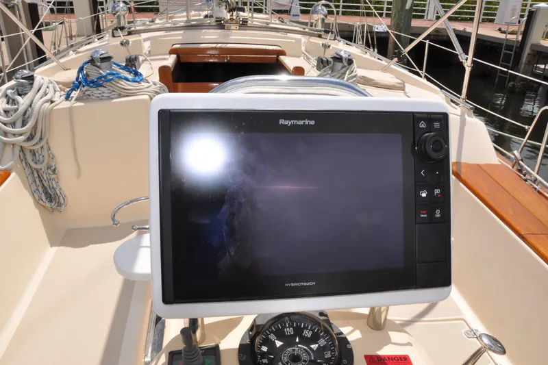 Slide: The Image of Raymarine navigation system on 2002 Island Packet 420 sailboat, with ropes and compass visible. - 31