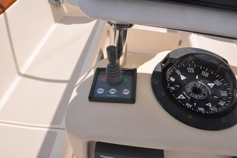 Slide: The Image of Control panel and compass on a 2002 Island Packet 420 sailboat. - 32
