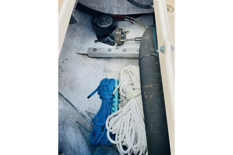 Slide: The Image of Storage compartment of 2002 Island Packet 420 sailboat with ropes and mechanical components. - 33