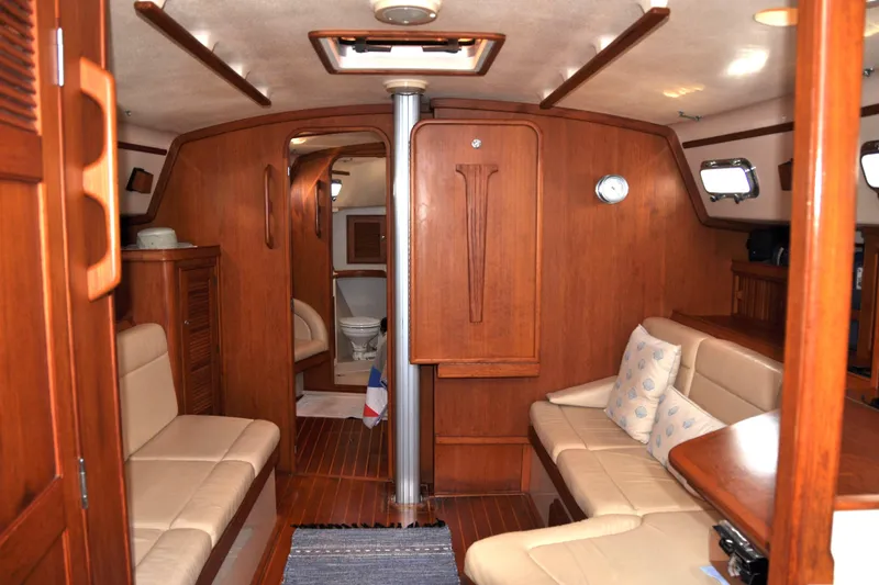Slide: The Image of Interior of 2002 Island Packet 420 yacht with wooden finish and beige seating. - 36