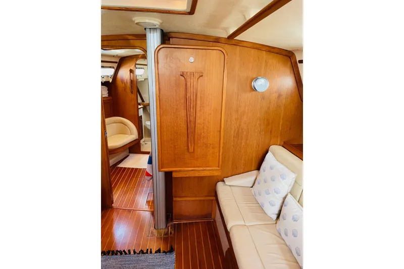 Slide: The Image of Interior of 2002 Island Packet 420 yacht with wooden paneling and cushioned seating. - 37