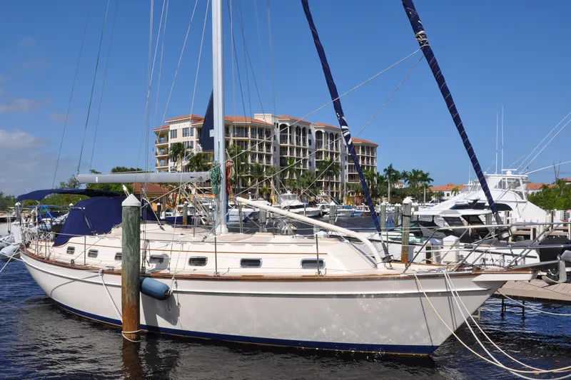 Slide: The Image of 2002 Island Packet 420 sailboat docked at marina with waterfront buildings. - 4