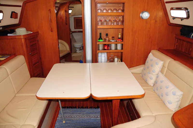 Slide: The Image of Interior of 2002 Island Packet 420 yacht with dining area and wooden cabinetry. - 42