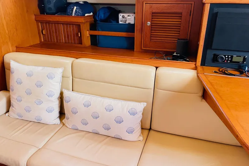 Slide: The Image of Interior of 2002 Island Packet 420 yacht with beige seating and shell-patterned pillows. - 43
