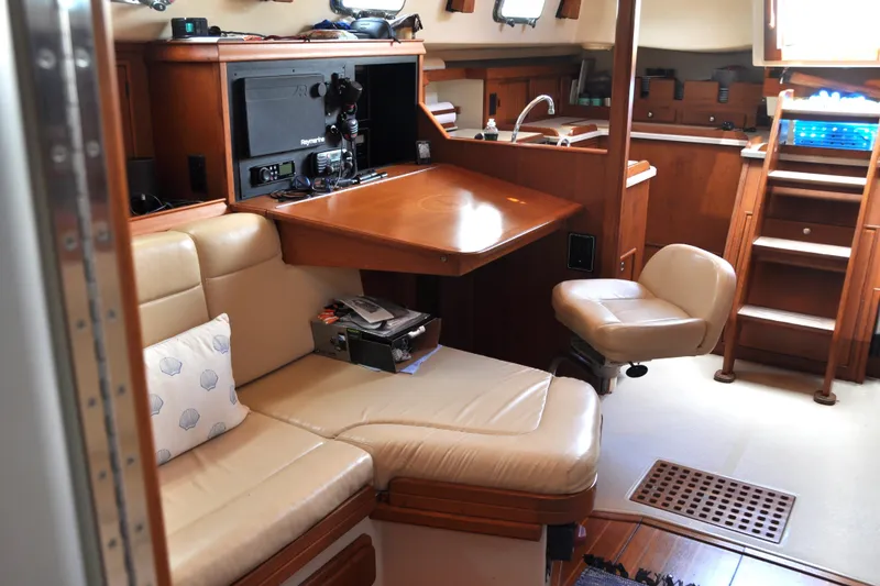Slide: The Image of Interior of 2002 Island Packet 420 yacht with cozy seating and navigation station. - 44