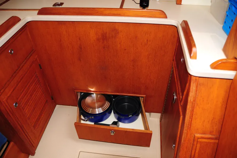 Slide: The Image of Wooden kitchen storage with open drawer on 2002 Island Packet 420 yacht. - 57