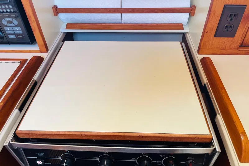Slide: The Image of Stove area on 2002 Island Packet 420 yacht with wooden accents and control panel. - 60