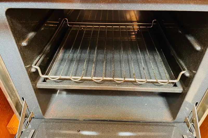 Slide: The Image of Empty oven interior with metal rack, viewed from the front. - 62