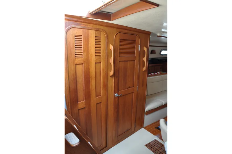 Slide: The Image of Interior of 2002 Island Packet 420 yacht featuring wooden cabinetry and seating area. - 63