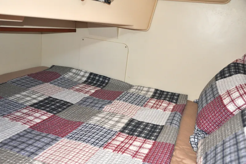 Slide: The Image of Cozy cabin bed with patchwork quilt in 2002 Island Packet 420 sailboat. - 66