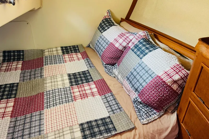 Slide: The Image of Cozy cabin bed with patchwork quilt on 2002 Island Packet 420 sailboat. - 67