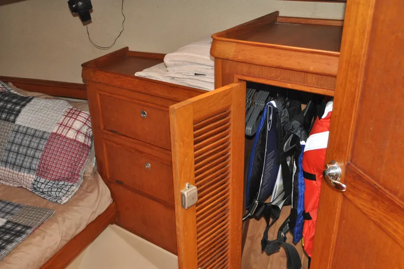 Slide: The Image of Cozy cabin interior of 2002 Island Packet 420 sailboat with wooden storage and bedding. - 69