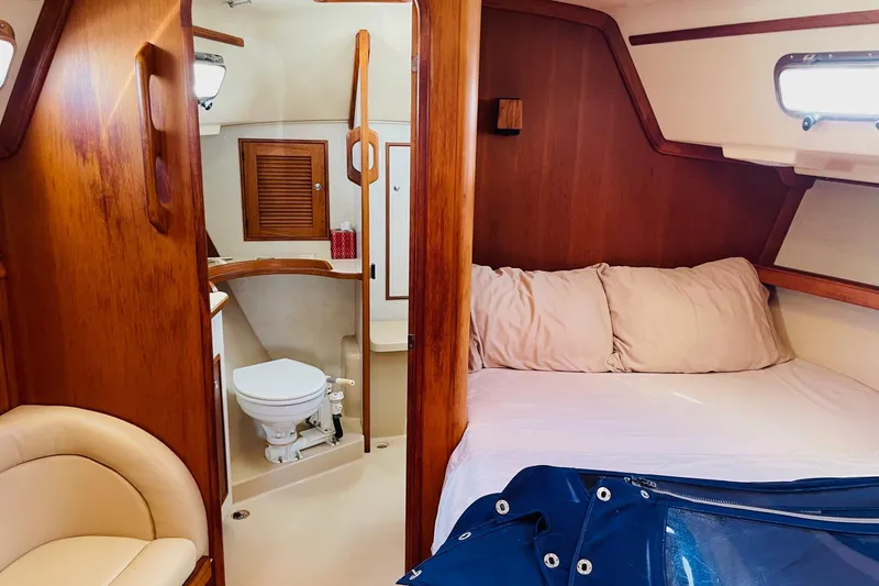 Slide: The Image of Cozy cabin interior of 2002 Island Packet 420 sailboat with bed and bathroom. - 73