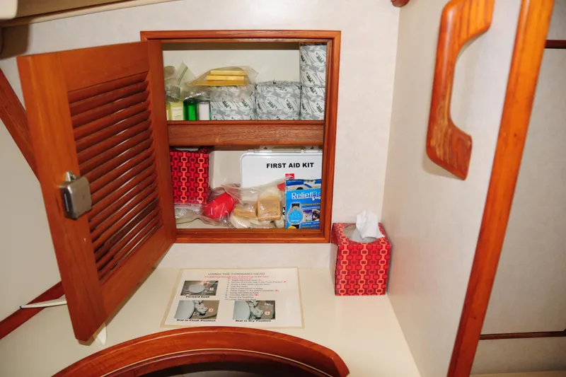 Slide: The Image of Cabinet with first aid kit and supplies on 2002 Island Packet 420 yacht. - 76
