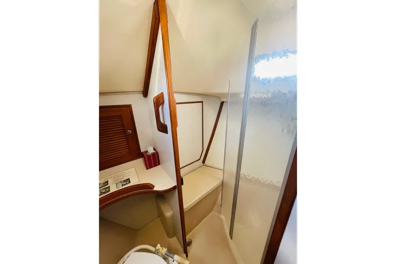 Slide: The Image of Interior of 2002 Island Packet 420 yacht bathroom with wooden accents and shower area. - 79