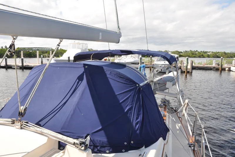 Slide: The Image of 2002 Island Packet 420 sailboat docked with blue canvas covers. - 8
