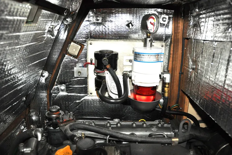 Slide: The Image of Engine compartment of 2002 Island Packet 420 sailboat with fuel filter and insulation. - 87
