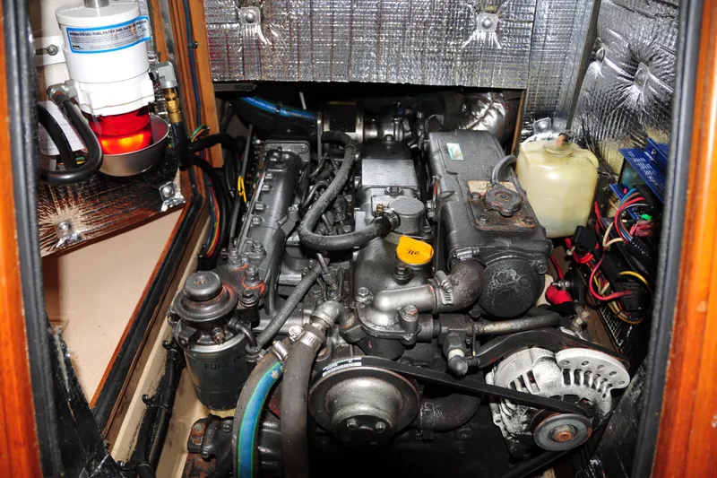 Slide: The Image of Engine compartment of a 2002 Island Packet 420 sailboat, showcasing detailed mechanical components. - 88