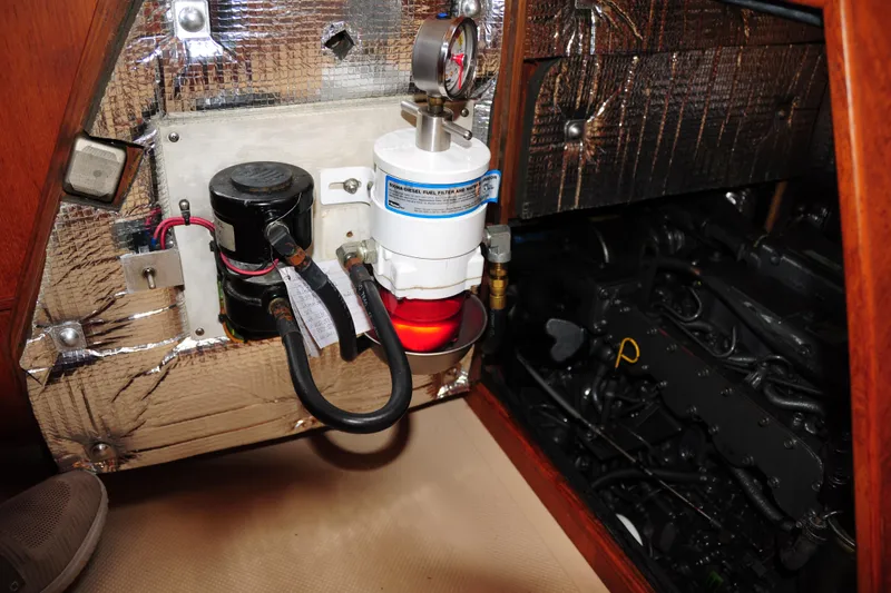 Slide: The Image of Engine compartment of 2002 Island Packet 420 sailboat with fuel filter and insulation. - 89