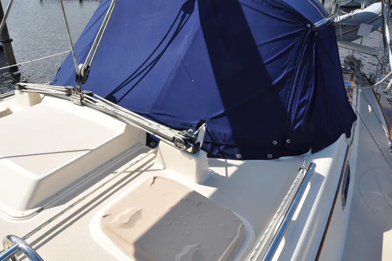 Slide: The Image of 2002 Island Packet 420 sailboat deck with blue canvas cover and rigging. - 9