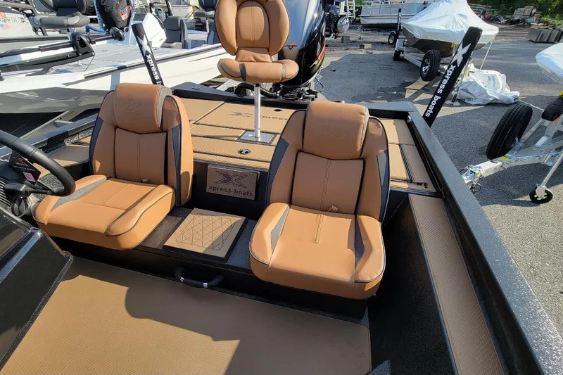 Slide: The Image of 2026 Xpress H20 Bass boat interior with tan seats and modern design. - 4