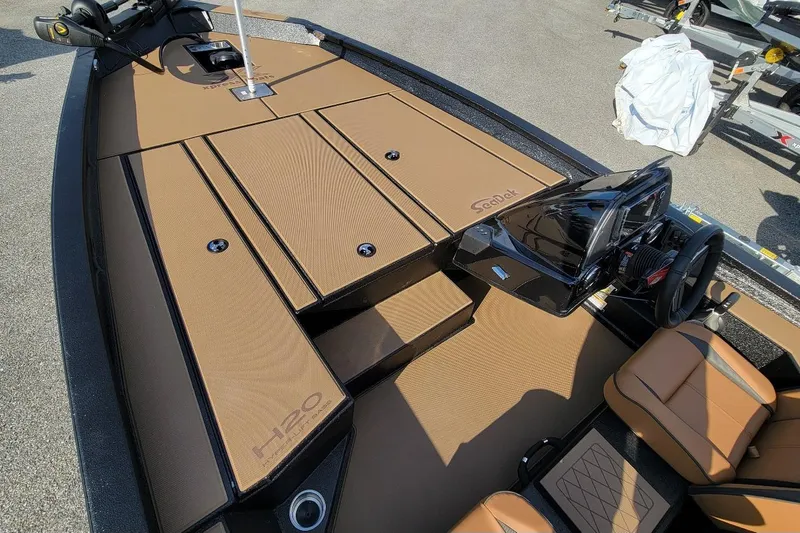 Slide: The Image of 2026 Xpress H20 Bass boat interior with tan seating and sleek black console. - 6