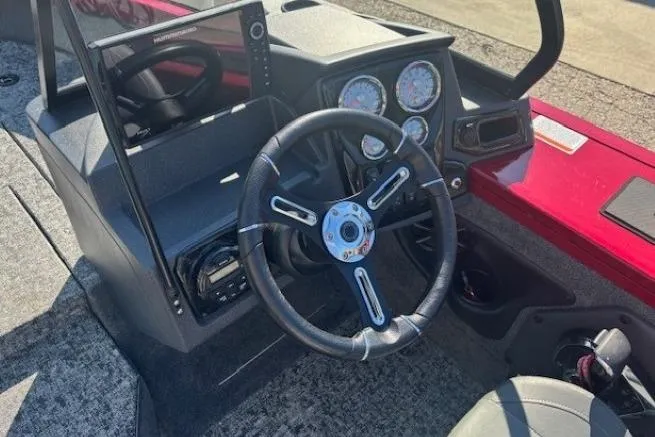 Slide: The Image of 2025 Tracker Targa V-19 WT Tournament Edition boat dashboard with steering wheel and gauges. - 14