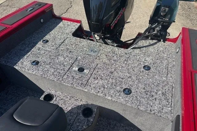 Slide: The Image of 2025 Tracker Targa V-19 WT Tournament Edition boat deck with motor, featuring gray carpeting. - 19