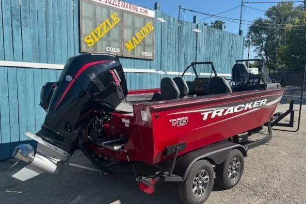 Slide: The Image of 2025 Tracker Targa V-19 WT Tournament Edition boat, red, parked at Sizzle Marine dealership. - 2