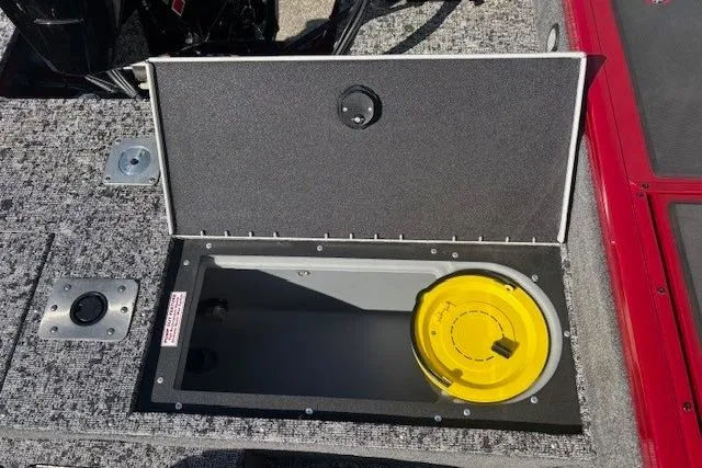Slide: The Image of 2025 Tracker Targa V-19 WT Tournament Edition boat storage compartment with yellow lid. - 20