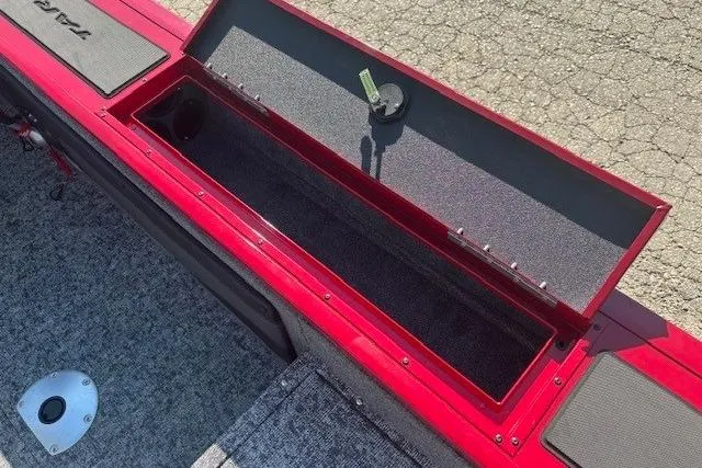 Slide: The Image of 2025 Tracker Targa V-19 WT Tournament Edition boat storage compartment, open on textured flooring. - 24