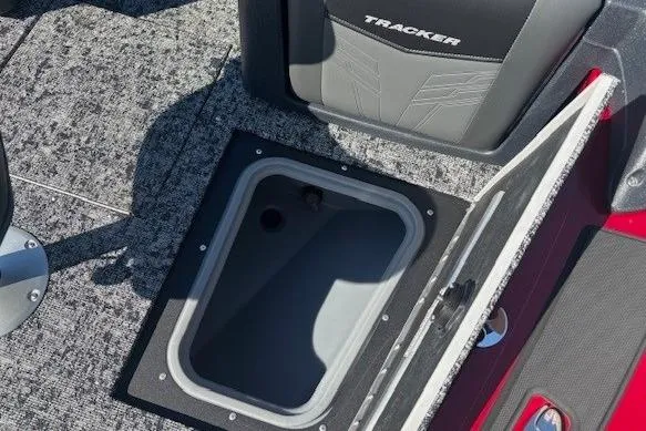 Slide: The Image of 2025 Tracker Targa V-19 WT Tournament Edition boat storage compartment, open lid, gray interior. - 9