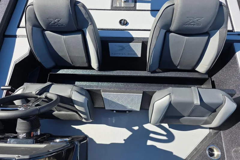 Slide: The Image of 2026 Xpress H20 Bass boat interior with sleek gray seating and steering wheel. - 14